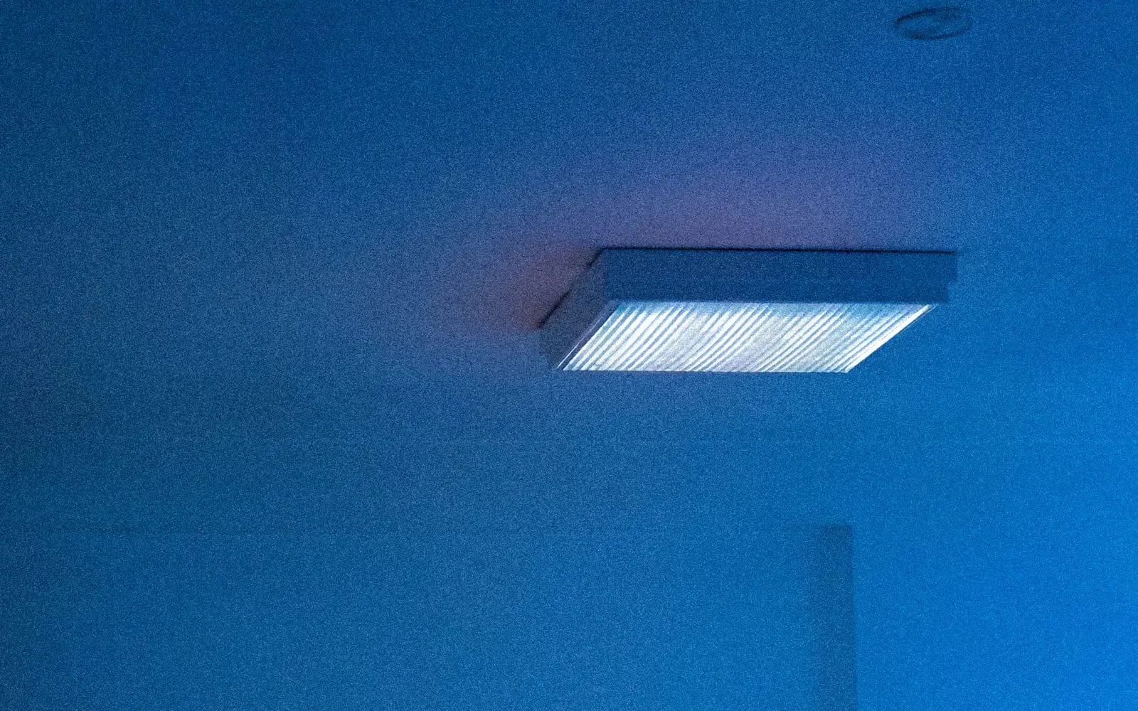 A patient resting at home after aesthetic surgery, following post-operative care guidance